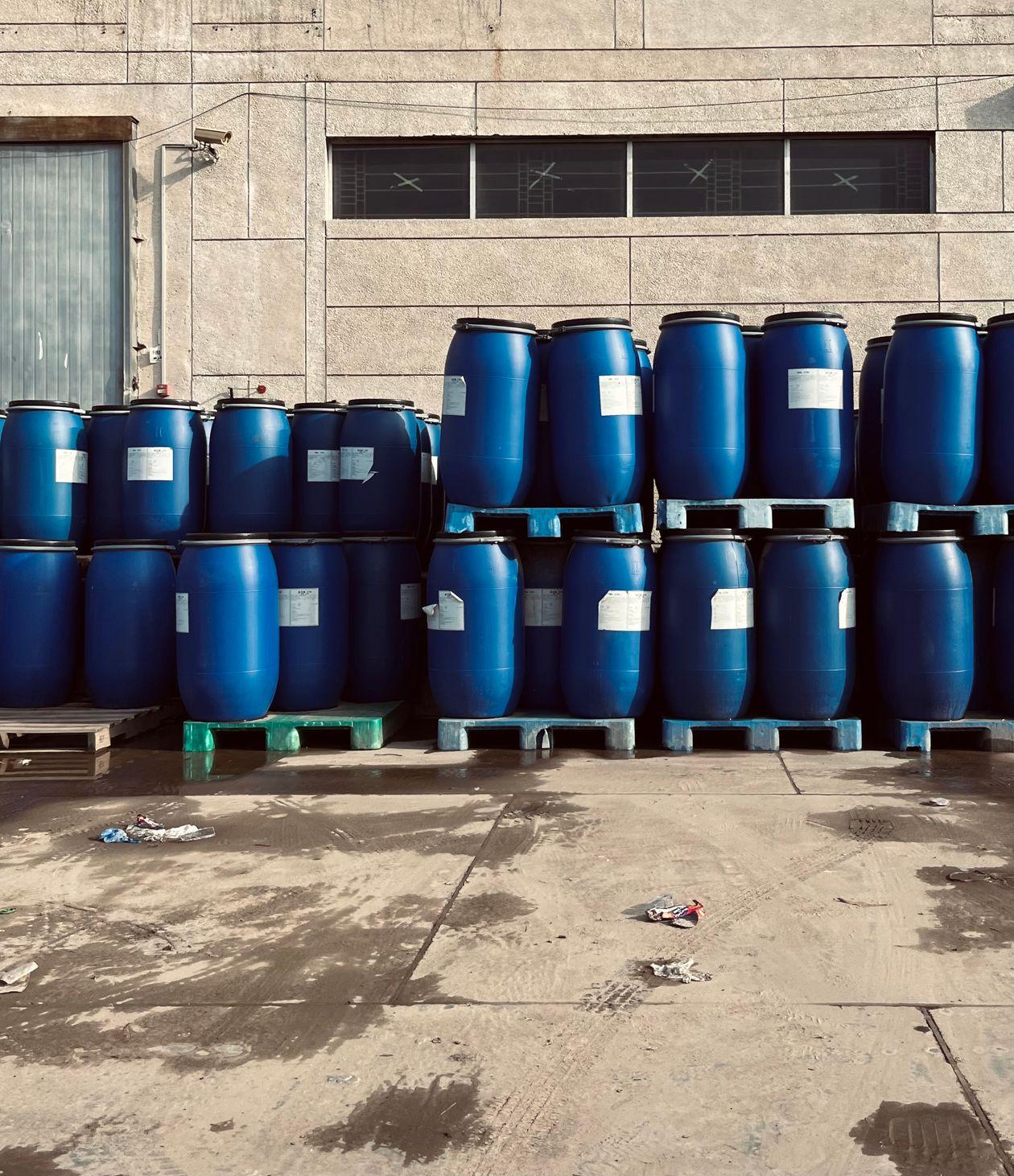 Blue industrial barrels stacked on pallets ready for export