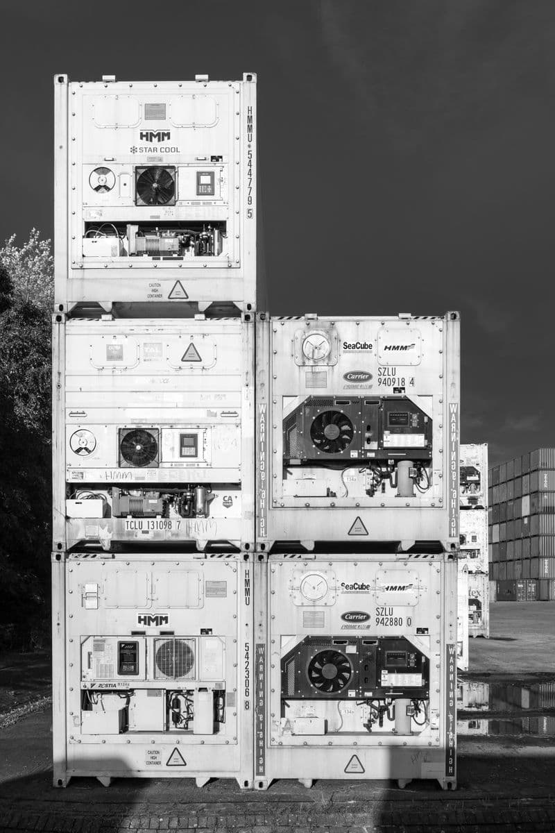 Shipping containers at port representing shipment milestone tracking